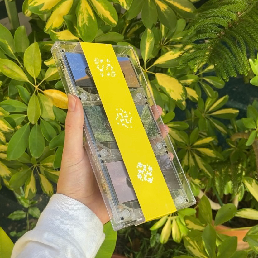 a yellow tripple tape backage in the sun with plants